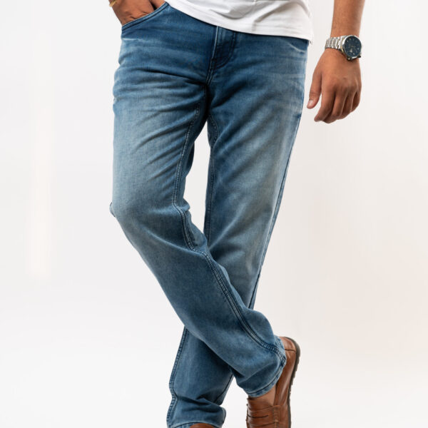 a person wearing blue jeans and a watch